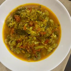 A picture of Turaii (Ridge gourd) with kalonji and curry leaf.