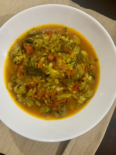 A picture of Turaii (Ridge gourd) with kalonji and curry leaf.