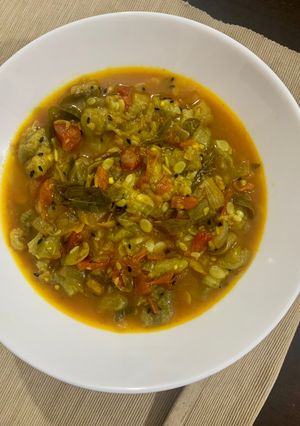 A picture of Turaii (Ridge gourd) with kalonji and curry leaf.