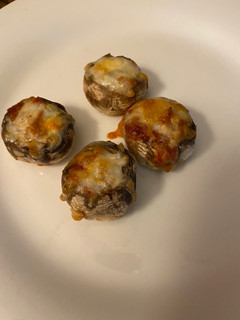 A picture of Stuffed pizza mushrooms.