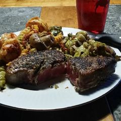 A picture of Brad's Blackened ahi with prawn buttered pasta and sautéed Brussels.