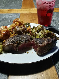 A picture of Brad's Blackened ahi with prawn buttered pasta and sautéed Brussels.
