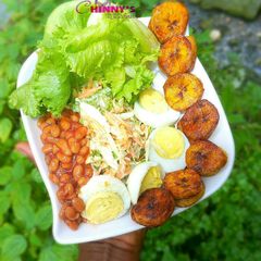 A picture of Veggie salad,baked beans hard boiled eggs and dodo.