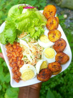 A picture of Veggie salad,baked beans hard boiled eggs and dodo.