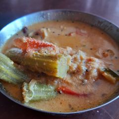A picture of Kerala style tomato drumstick gravy.
