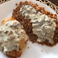 A picture of Chicken breast stuffed with mushrooms poured mushroom sauce.