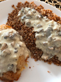 A picture of Chicken breast stuffed with mushrooms poured mushroom sauce.