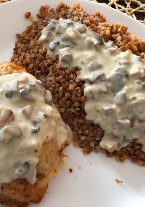 A picture of Chicken breast stuffed with mushrooms poured mushroom sauce.