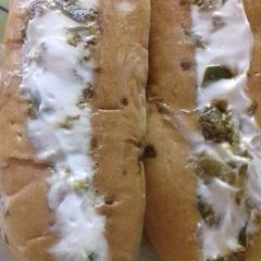 A picture of Hot dog with lots of veggies.