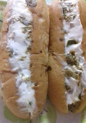 A picture of Hot dog with lots of veggies.