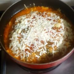 A picture of Baked spinach paneer cannelloni with tomato sauce and veggies.
