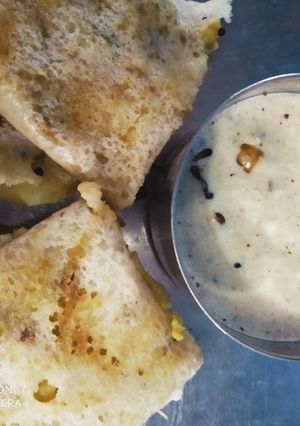 A picture of Masala Dosa with Coconut Chutney.