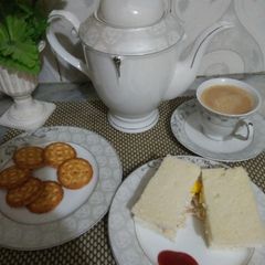 Chicken egg sandwitch with tea A picture of Chicken egg sandwitch with tea.