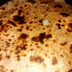 A picture of Raagi roti with butter.