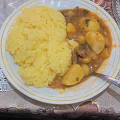 A picture of Beef stew and rice.