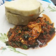 A picture of Boiled yam with shredded chicken and vegetable stew.