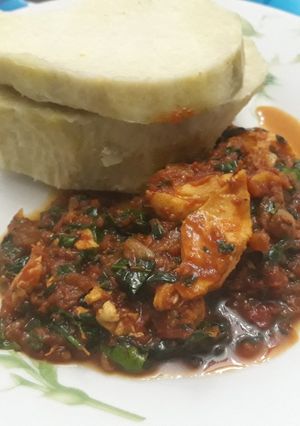 A picture of Boiled yam with shredded chicken and vegetable stew.