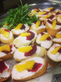 A picture of Goats cheese, mango and beetroot crostini.