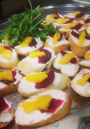 A picture of Goats cheese, mango and beetroot crostini.