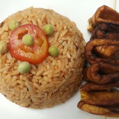 A picture of Jollof rice with fried plantain.