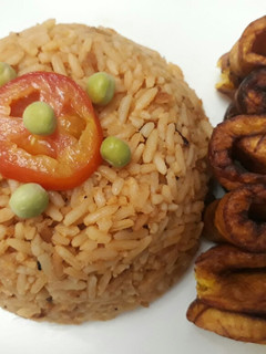 A picture of Jollof rice with fried plantain.