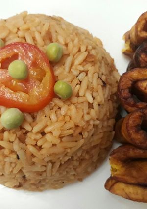 A picture of Jollof rice with fried plantain.