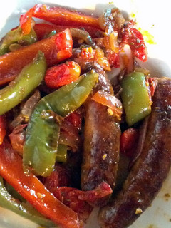 A picture of Sausages and peppers.