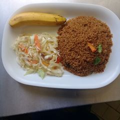 A picture of Beef pilau Rice, steamed cabbages n a banana.