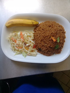 A picture of Beef pilau Rice, steamed cabbages n a banana.