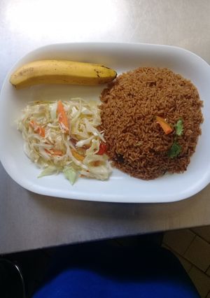 A picture of Beef pilau Rice, steamed cabbages n a banana.