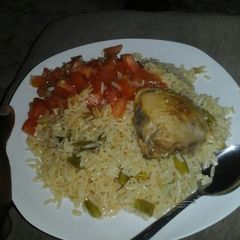 A picture of Green beans and onion rice with tomato salad.
