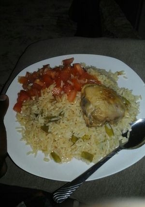 A picture of Green beans and onion rice with tomato salad.