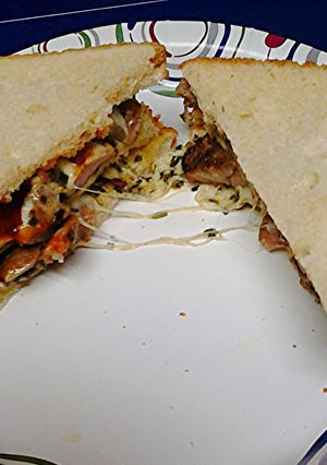 A picture of Grilled pork steak sandwich.