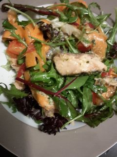 A picture of Filling healthy dinner: salmon salad with horsradish dressing and garlic bread on the side.