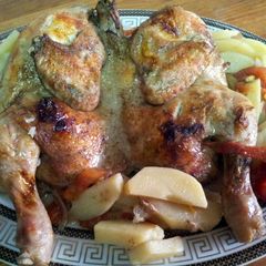 A picture of baked chicken with potatoes.