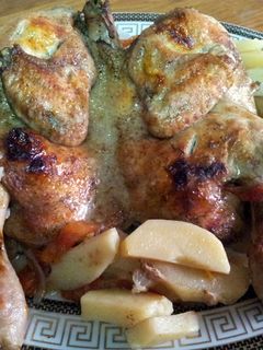 A picture of baked chicken with potatoes.