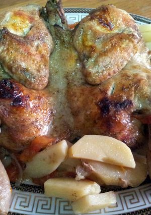 A picture of baked chicken with potatoes.