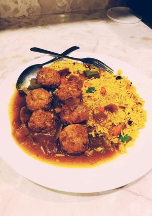 A picture of Vegetables Manchurian gravy with fried rice.