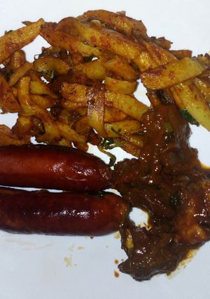A picture of Chips masala, wetfry beef with sausages.