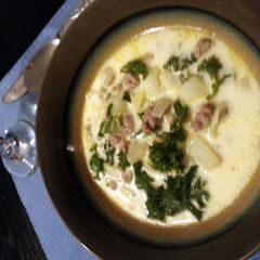 A picture of sausage, potato, and kale soup.