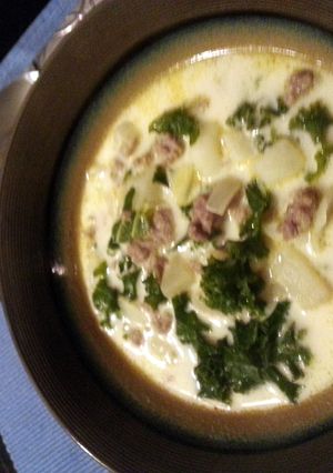 A picture of sausage, potato, and kale soup.