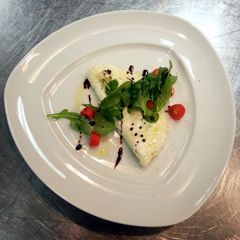A picture of White omlet with rocket salad.