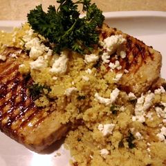 A picture of Lemon Herb Couscous With Grilled Pork Chops.