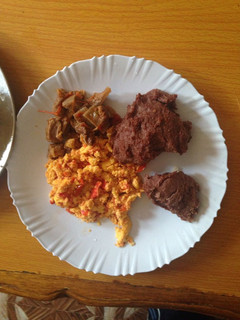 A picture of Left over beef and scrambled eggs served with brown ugali.