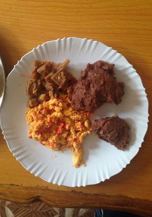 A picture of Left over beef and scrambled eggs served with brown ugali.