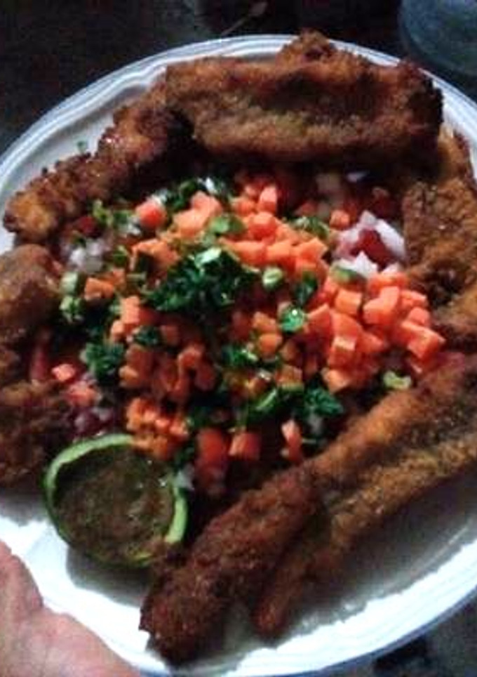 Una foto de Pescado empanizado con pico de gallo y salsa