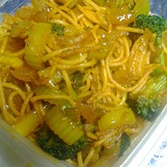 A picture of Golden noodles with bits of Emeralds.