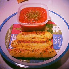 A picture of Cheese Stuffed Bread Sticks w/ Garlic Butter and Parsley.
