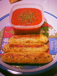 A picture of Cheese Stuffed Bread Sticks w/ Garlic Butter and Parsley.