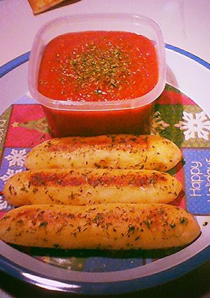 A picture of Cheese Stuffed Bread Sticks w/ Garlic Butter and Parsley.